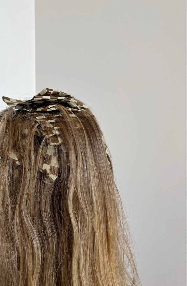 Close-up of tape-in extensions applied at the root