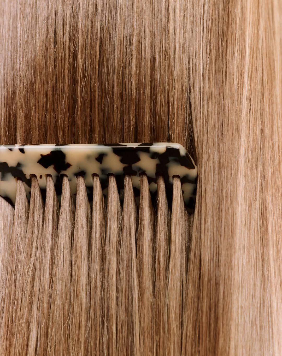 Tortoiseshell comb through sleek, smooth keratin-treated hair