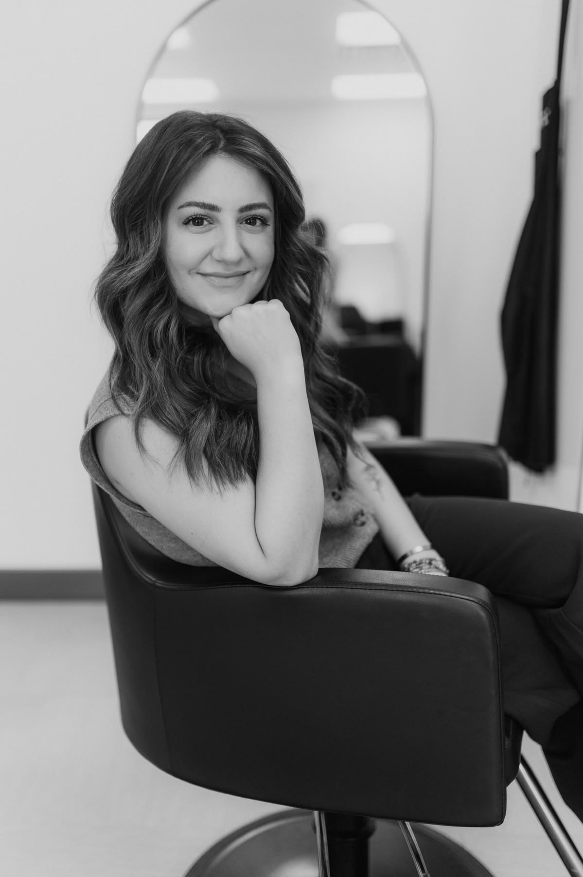 Portrait of Bianca, Blondie Hair Salon FL master stylist, seated in the studio
